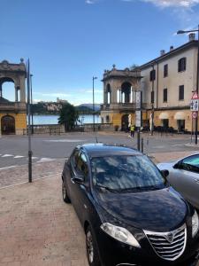 a black car parked on the side of a street at La Casolicchia di Arona in Arona