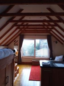 a living room with a large window in a room at Rose Cottage studio in Sheffield