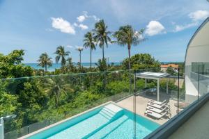 an ocean view from the balcony of a house with a swimming pool at Villa Zen Sushi in Lamai