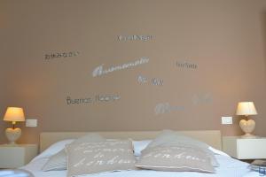 a bedroom with a bed with words on the wall at B&b Mondello Resort in Palermo