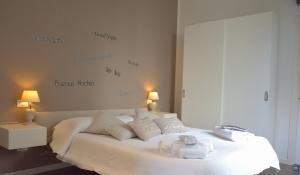 a bedroom with a white bed with towels on it at B&b Mondello Resort in Palermo
