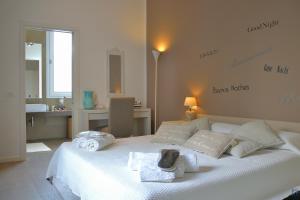a bedroom with a white bed with towels on it at B&b Mondello Resort in Palermo