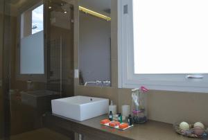 a bathroom with a sink and a large mirror at B&b Mondello Resort in Palermo