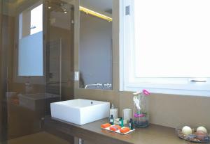 a bathroom with a sink and a mirror at B&b Mondello Resort in Palermo