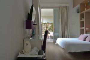 a bedroom with a bed and a view of a patio at B&b Mondello Resort in Palermo +37 photos