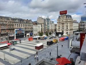 a city square with buildings and people walking around at Super central in Brussels in Brussels +136 photos