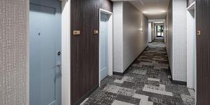 corridoio di un corridoio con porte e pavimento piastrellato di Staybridge Suites - Denver North - Thornton, an IHG Hotel a Thornton