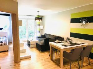 a living room with a table and a couch at Apartament LATARNIKA in Jastrzębia Góra