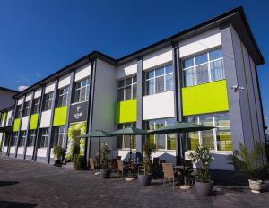 an exterior view of a building with tables and umbrellas at Antari in Slatina