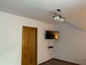 a room with a door and a tv on the wall at Belle View Apartment Sinaia in Sinaia