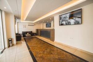 a living room with a couch and a tv on a wall at Joar Beach Hotel in Aqaba