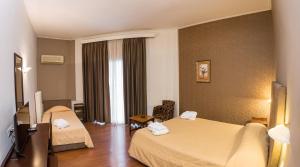 Postel nebo postele na pokoji v ubytování Achillion Hotel