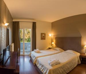 Postel nebo postele na pokoji v ubytování Achillion Hotel