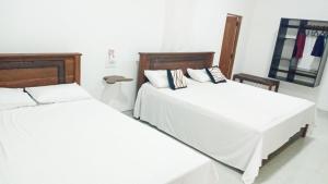 Ein Bett oder Betten in einem Zimmer der Unterkunft Sigiri Suncap Cottage