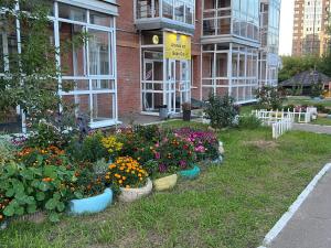 a garden of flowers in front of a building at Good Cat in Irkutsk