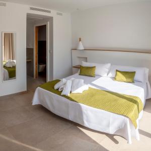 מיטה או מיטות בחדר ב-Hotel Senderos