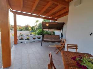 a patio with a couch and a table and chairs at Il Patio Alghero in Santa Maria la Palma