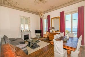 a living room with a table and a fireplace at Mont Boron Magnificent View-3 Rooms - Wifi - A.C in Nice