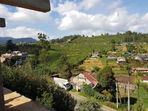 a small village on a hill with a view at Hotel ColdWorld in Nuwara Eliya
