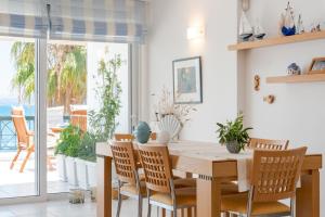 a dining room with a table and chairs at Beachfront Modern Apartment in Eretria