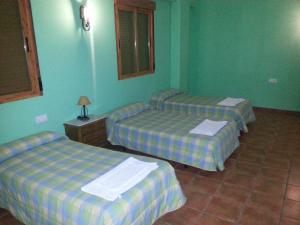 Postel nebo postele na pokoji v ubytování Hostal las Tres Jotas + 27 fotografií