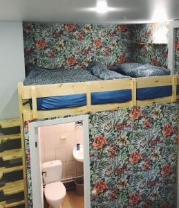 two bunk beds in a room with a toilet and a bathroom at Gallery Hostel in Kazan