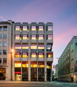 a tall building with many windows on a city street at easyHotel Liverpool in Liverpool