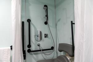 a shower stall in a bathroom with a shower at easyHotel Sheffield in Sheffield +17 photos