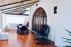 a room with a table and chairs and a door at Casa Diana Arianna in Lipari