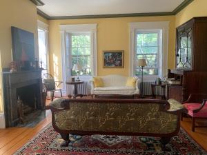 a living room with a couch and a fireplace at Delano Homestead Bed and Breakfast in Fairhaven