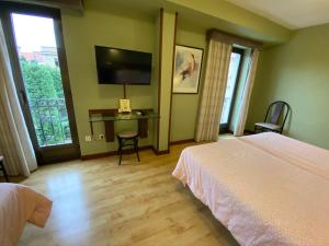 Postel nebo postele na pokoji v ubytování Hostal Concejo