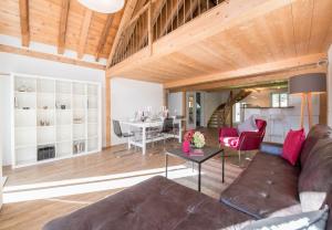 a living room with a couch and a table at Le Manoir Penthouse in Wengen