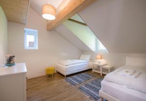 a attic room with two beds and a couch at Le Manoir Penthouse in Wengen
