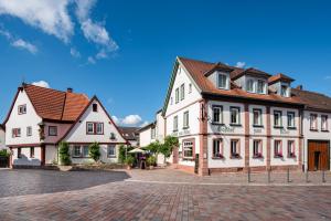 a group of buildings on a cobblestone street at Adler Landhotel in Buergstadt