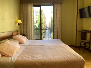 Postel nebo postele na pokoji v ubytování Hostal Concejo