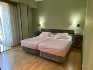Postel nebo postele na pokoji v ubytování Hostal Concejo