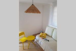 a bedroom with a bed and a yellow table at Ático de diseño sobre la Cala de las Sirenas!! in Miami Platja +41 photos