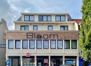a building with a sign on the front of it at Bloomhotel in Lochristi