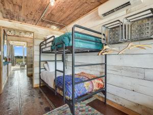 a bedroom with two bunk beds in a trailer at FlopHouze Shipping Container Hotel in Round Top