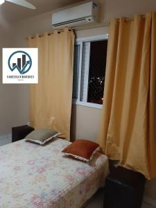 Ein Bett oder Betten in einem Zimmer der Unterkunft Apartamento Praia Grande