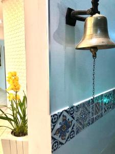 una campana colgando en el costado de una pared en Hotel Appel, en Santa Maria