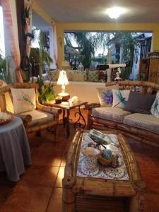 Casa Bonita Inn في لا بارغيرا: غرفة معيشة مع كنب وطاولة قهوة