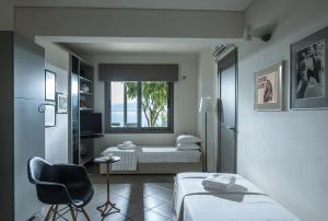 a small bedroom with a bed and a window at Skajado Holiday Apartments in Stalís