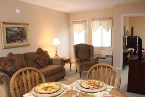a living room with a couch and a table and chairs at Gatlinburg Chateau Condo 302 in Gatlinburg