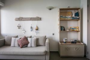 a living room with a couch and a table at Skajado Holiday Apartments in Stalís