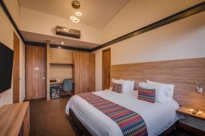 Ένα ή περισσότερα κρεβάτια σε δωμάτιο στο Alko Hotel Integrado
