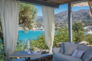 a living room with a couch and a view of the ocean at Skajado Holiday Apartments in Stalís