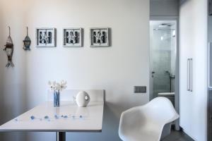 a white table and a white chair in a bathroom at Skajado Holiday Apartments in Stalís