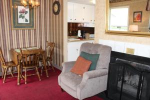 a living room with a chair and a table at Oak Square 201 in Gatlinburg