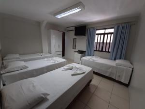 Giường trong phòng chung tại Pousada Damasco